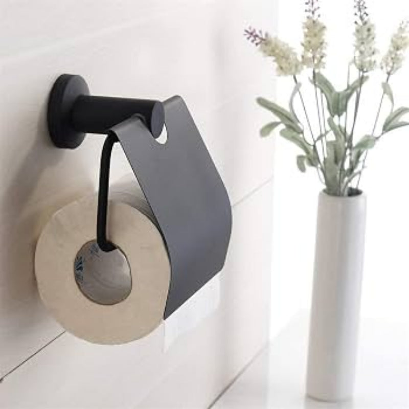 Matte black toilet paper holder with a protective cover mounted on a white background, displaying a single roll of toilet paper.